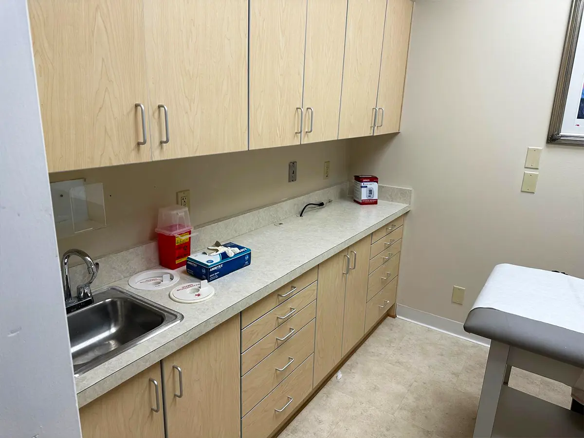Modern medical supply storage and sink area with essential equipment for patient care.