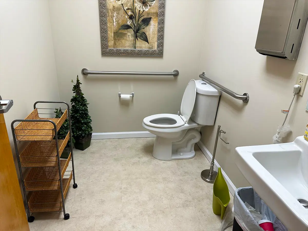 Accessible Restroom with Safety Rails and Modern Decor