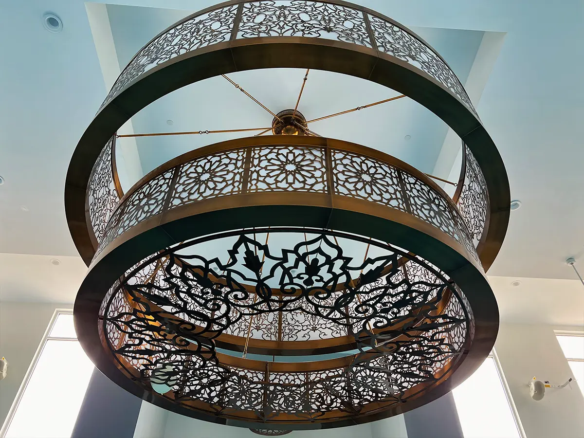 Close-up of detailed Islamic chandelier design - Featuring an ornate chandelier with geometric patterns in a modern mosque.